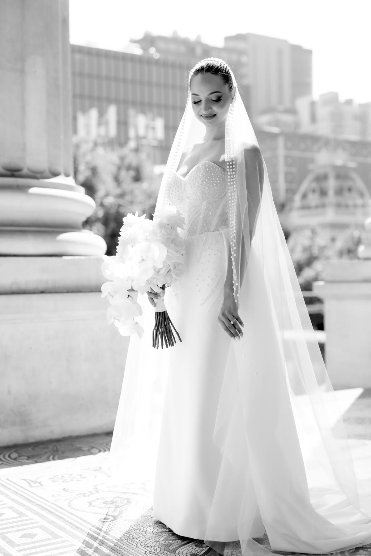 Bride glowing in sunlight with the city behind her
